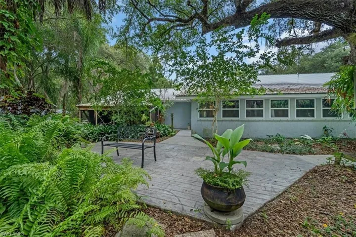 Rear view of home and open patio