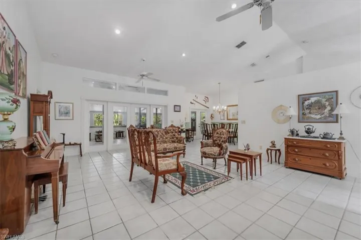 Great room with vaulted ceiling and double door entry to lanai