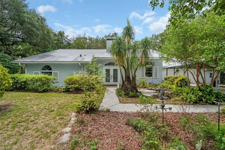 Front view of home with detached double carport