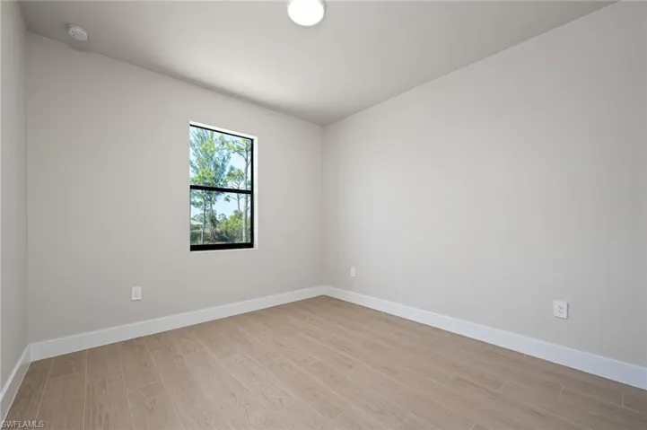 Unfurnished room with light hardwood / wood-style floors