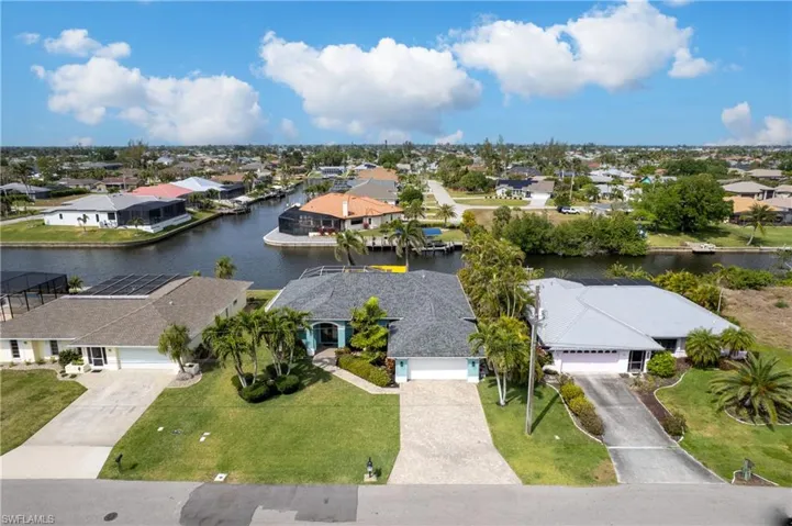 Birds eye view of property with a residential view and a water view