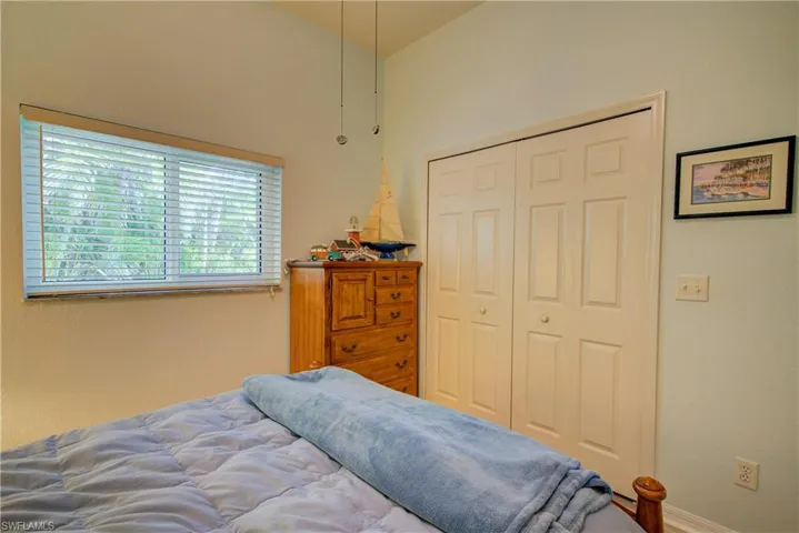 Bedroom with a closet and lofted ceiling