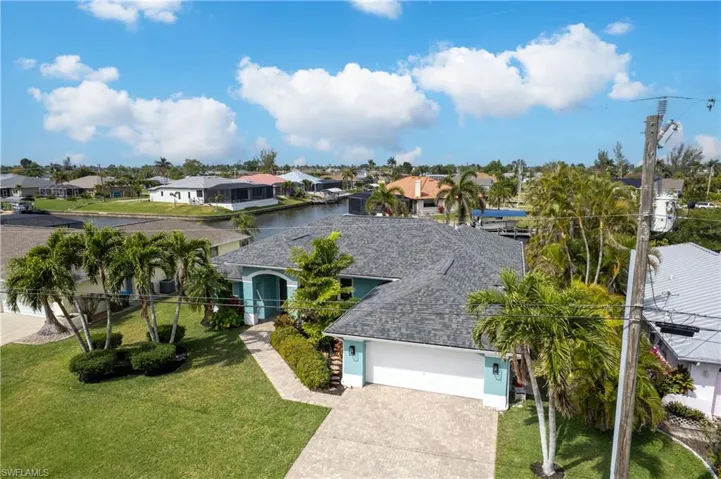 View of front of property with roof with shingles, a residential view, driveway, a front yard, and a garage