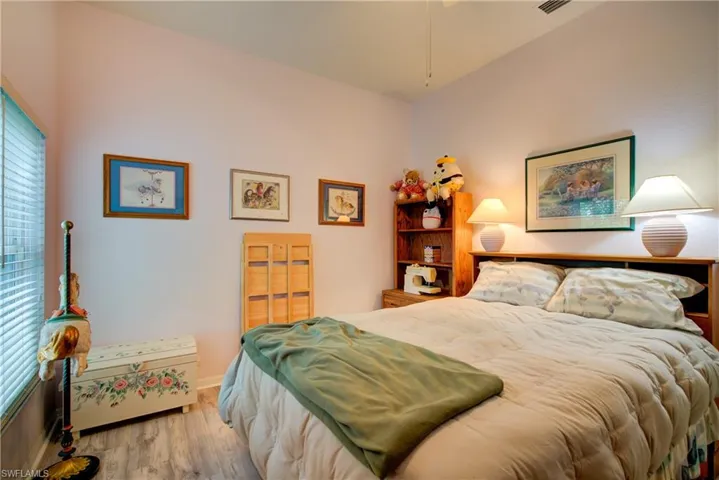 Bedroom featuring baseboards and wood finished floors