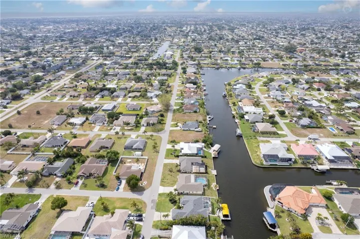 Birds eye view of property with a residential view and a water view
