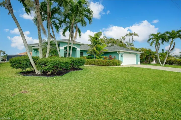 Single story home with driveway, a garage, a front lawn, and stucco siding