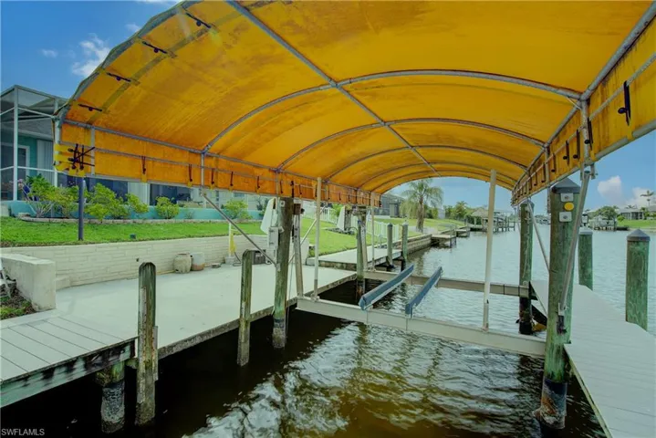 Dock area with boat lift and a water view