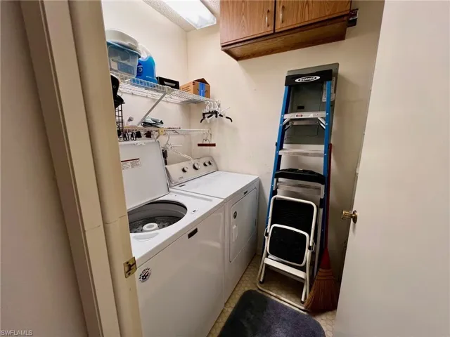 Laundry room with independent washer and dryer and cabinet space