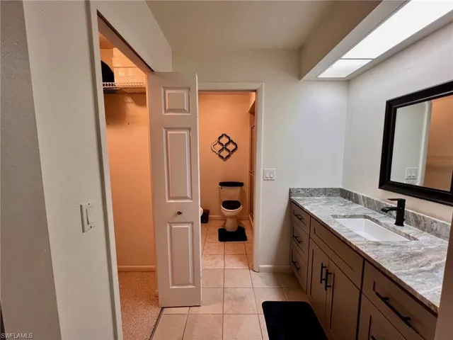 Full bath featuring vanity and light tile patterned floors