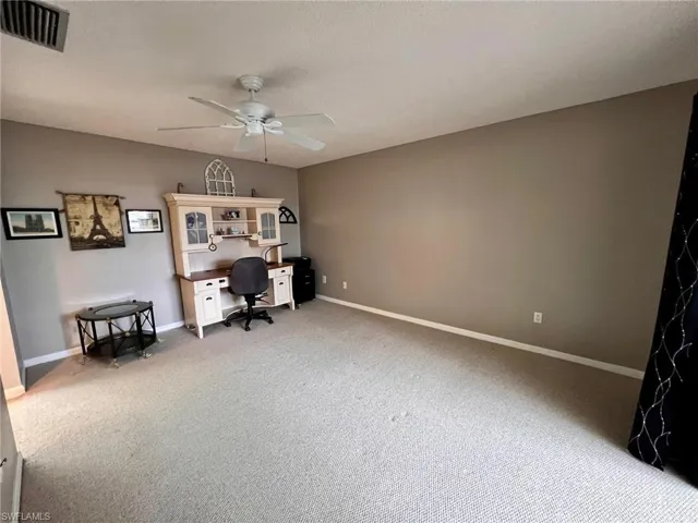 Office featuring ceiling fan, light colored carpet, and a textured ceiling