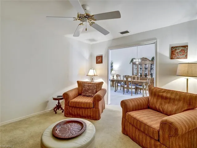 Sitting room featuring carpet flooring and a ceiling fan