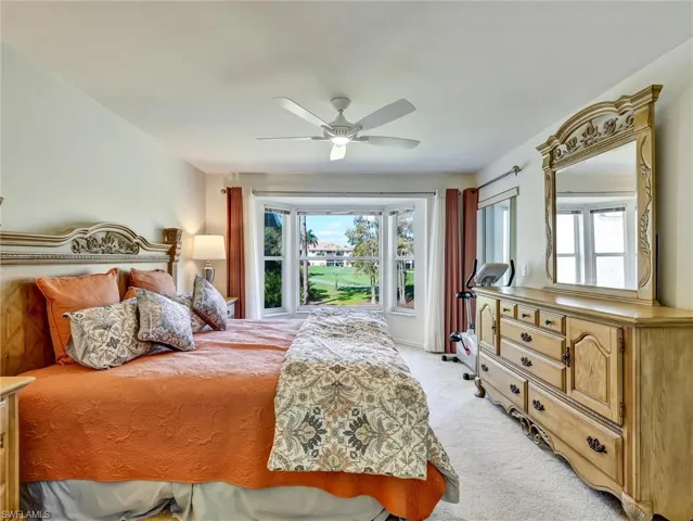 Bedroom featuring light carpet and a ceiling fan