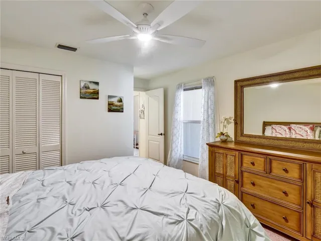 Bedroom with a ceiling fan and a closet