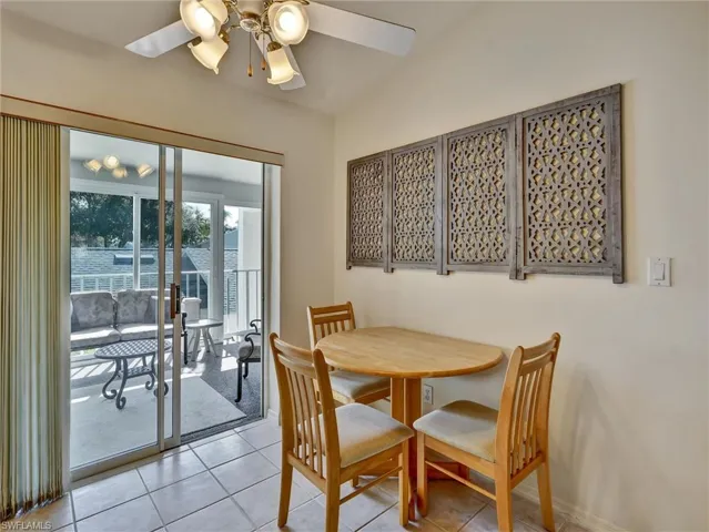 Dining space with light tile patterned floors and ceiling fan