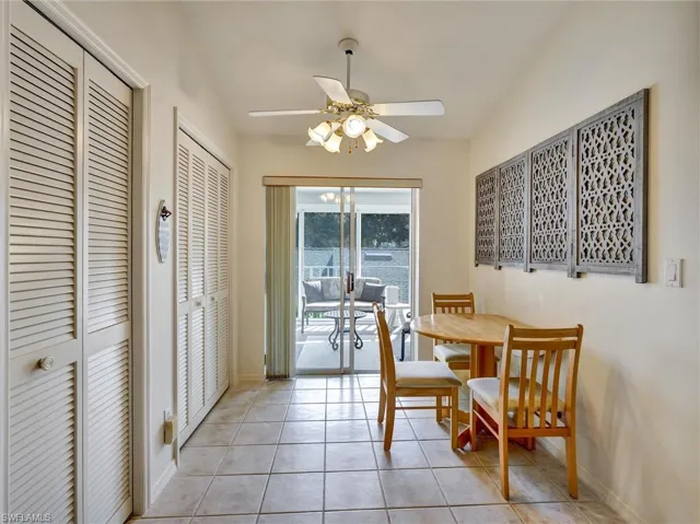 Dining area featuring light tile patterned floors and ceiling fan