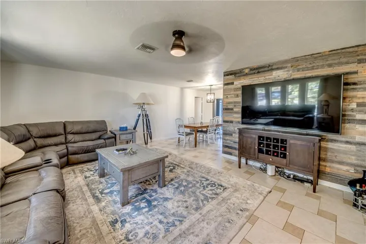 Living room with baseboards and ceiling fan