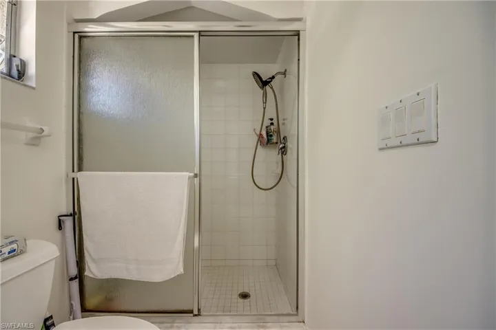 Bathroom with a stall shower and toilet