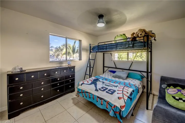 Bedroom with a ceiling fan and light tile patterned floors