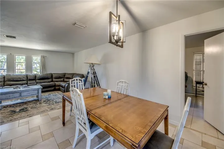 Dining room featuring a chandelier and light tile patterned floors