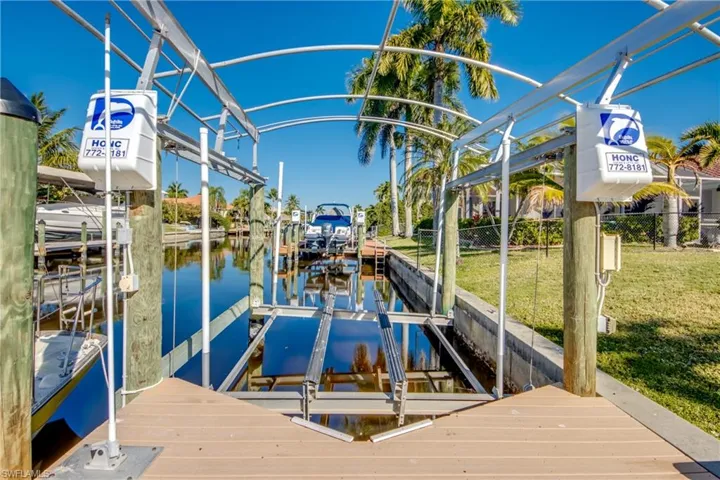 Dock featuring boat lift and a water view
