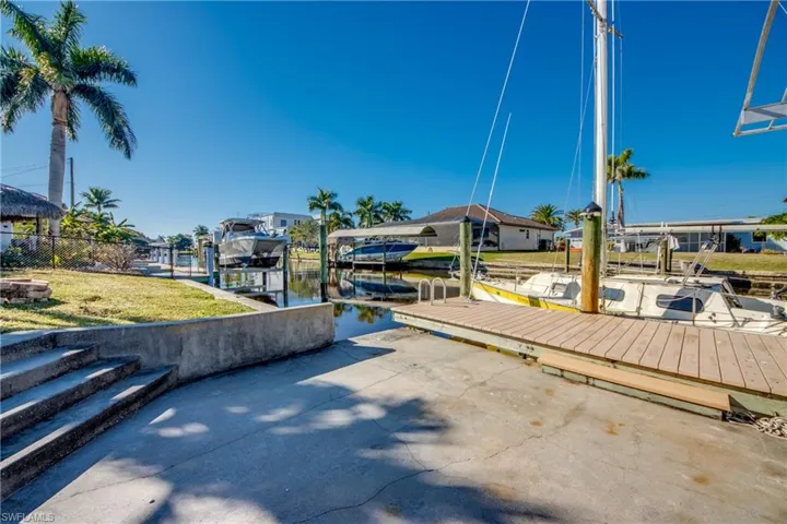 Dock area with a water view and boat lift