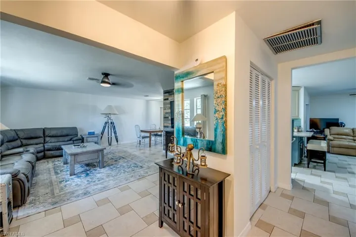 Living area featuring ceiling fan and baseboards