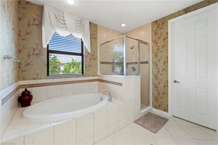 Built-in soaking tub with tile surround and coordinated accent trim