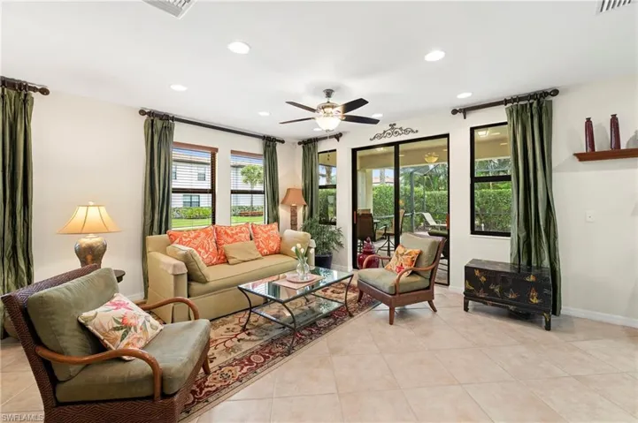 Open-concept living space featuring tile flooring and recessed lighting