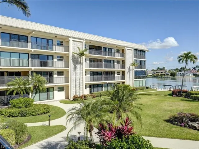 View of community featuring a water view and a yard