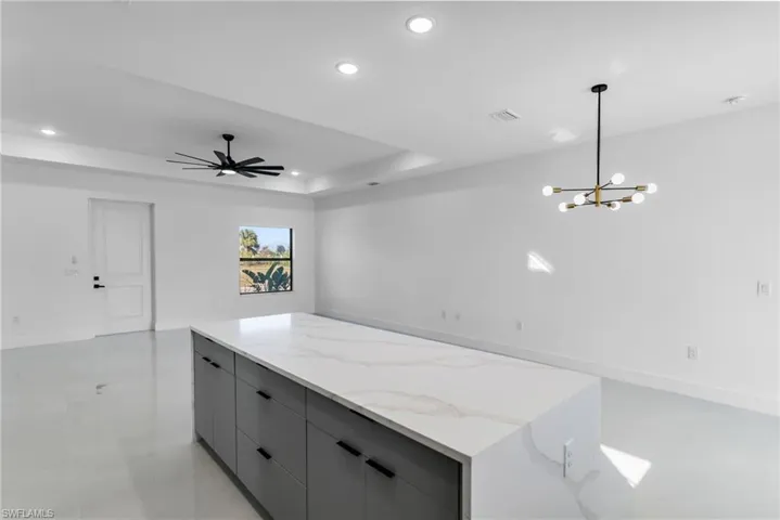 Kitchen featuring recessed lighting, gray cabinetry, modern cabinets, open floor plan, and a center island