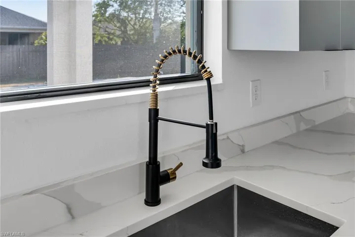 Kitchen view of light stone countertops