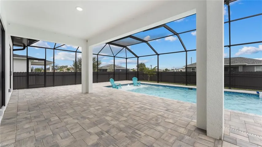 View of pool featuring a patio, a fenced backyard, and a lanai