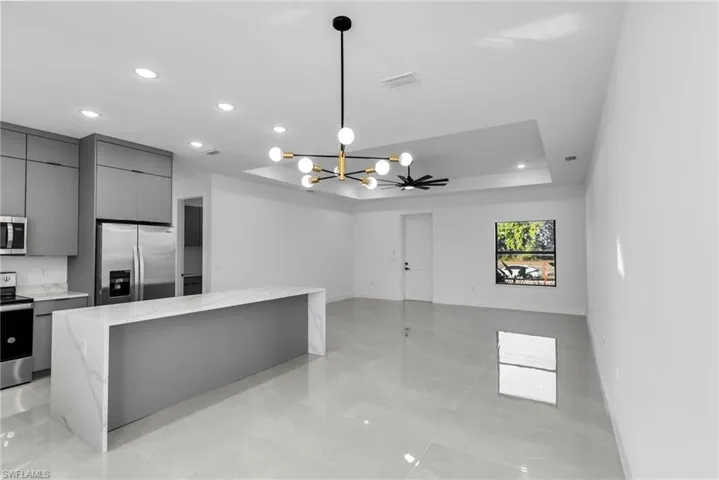 Kitchen featuring appliances with stainless steel finishes, modern cabinets, gray cabinets, recessed lighting, and a kitchen island