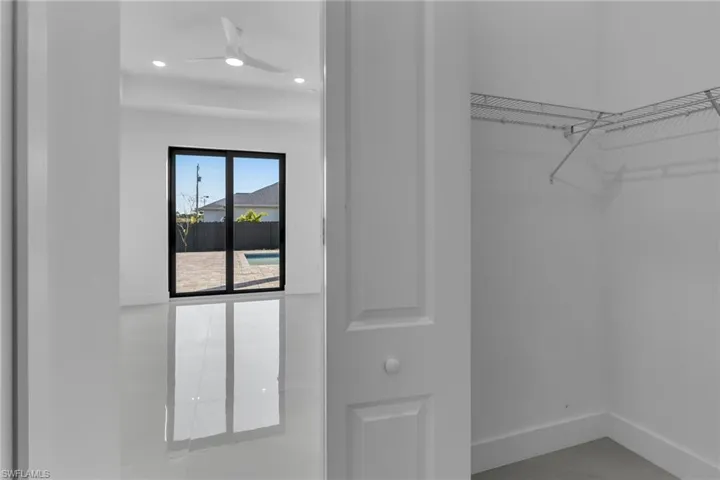 Walk in closet featuring a ceiling fan