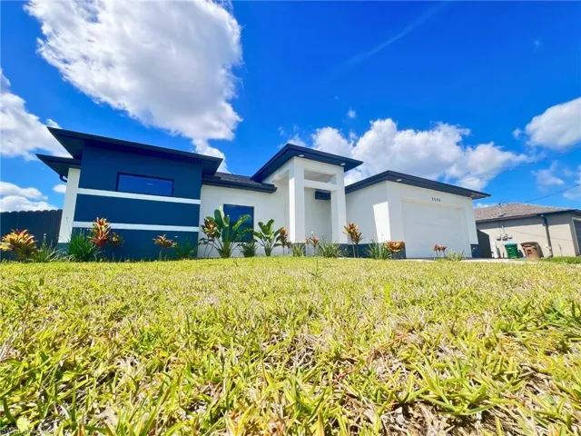 View of front of property with stucco siding and a garage
