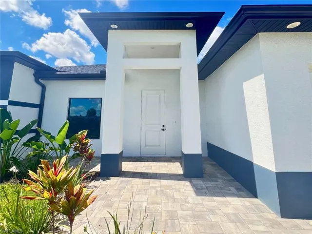 Property entrance featuring stucco siding