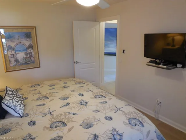 Bedroom with hardwood / wood-style floors and ceiling fan