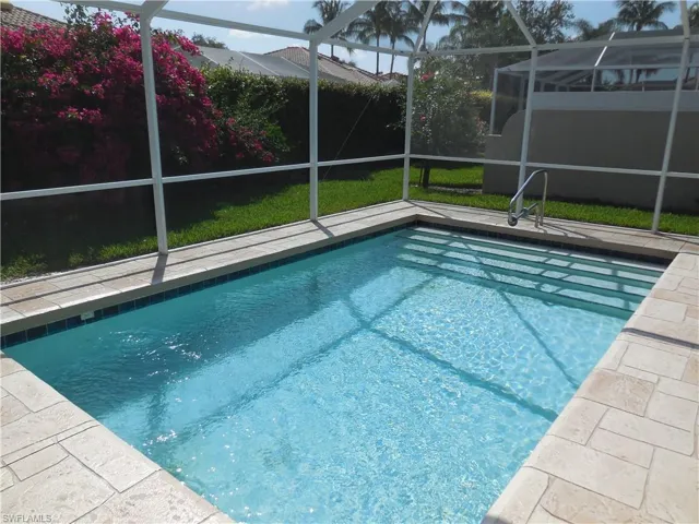 View of swimming pool featuring a lanai