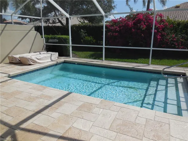 View of swimming pool featuring a lanai and a patio area