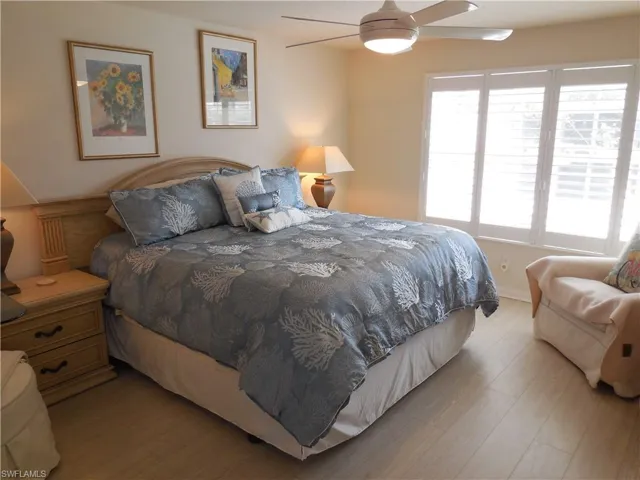 Bedroom with ceiling fan and wood-type flooring