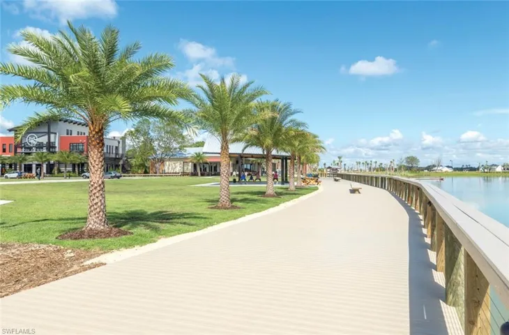 View of home's community with a water view and a yard