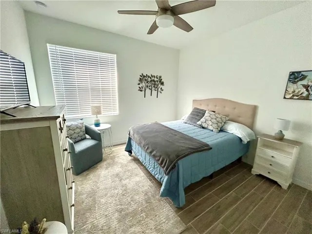 Bedroom with wood-type flooring and ceiling fan