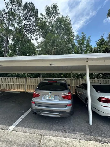View of parking featuring a carport