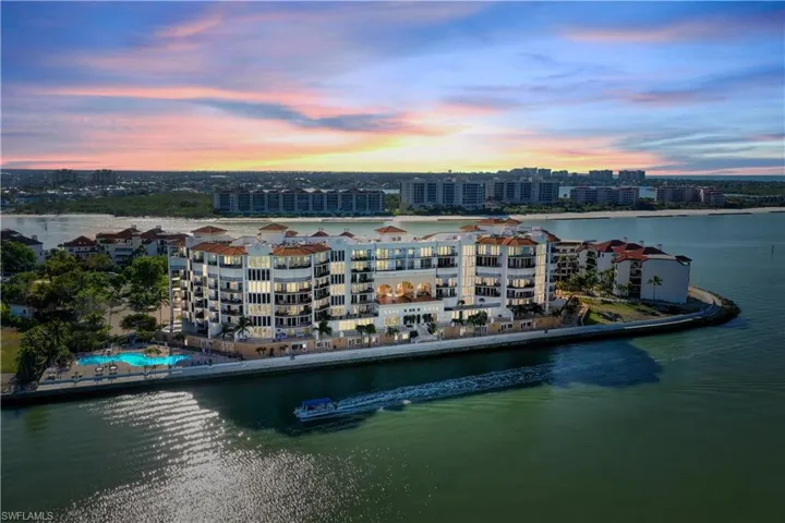 Aerial view at dusk featuring a water view