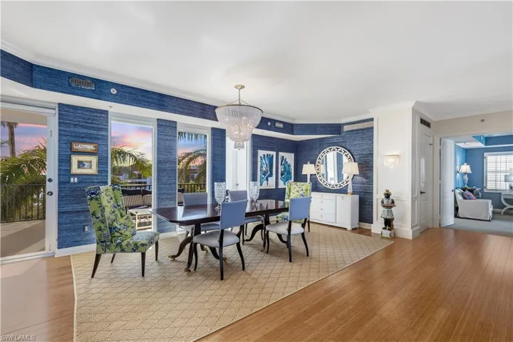 Dining space featuring a chandelier, hardwood / wood-style flooring, and crown molding