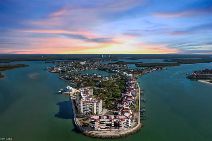 Aerial view at dusk featuring a water view