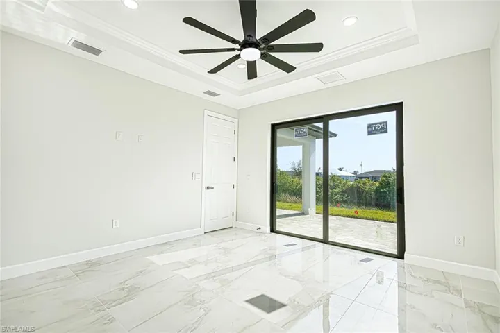 Spare room featuring ceiling fan, a raised ceiling, and ornamental molding