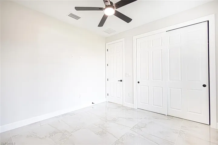 Unfurnished bedroom featuring ceiling fan and a closet