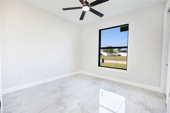 Unfurnished room featuring ceiling fan
