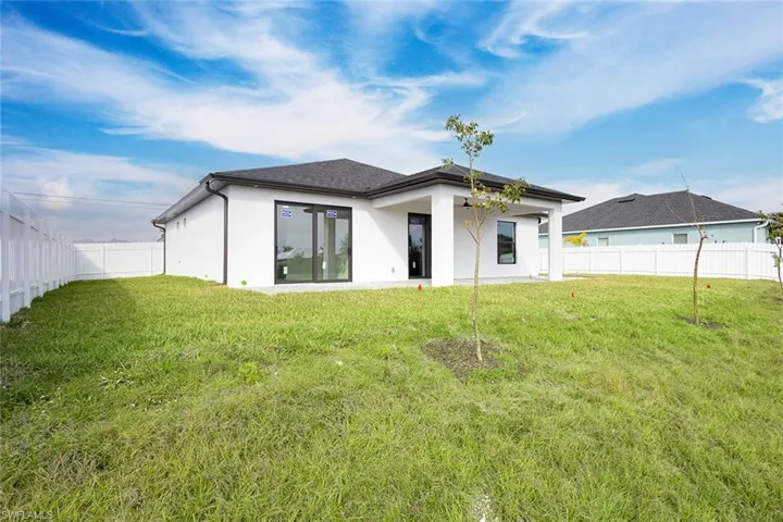Back of house featuring a yard
